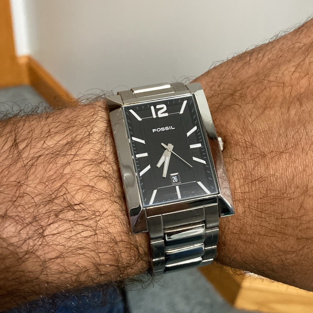 Fossil tank style rectangular case watch, black dial. Stainless steel.